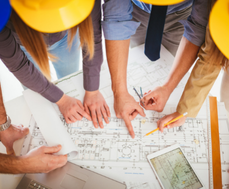 Young architect team discussing construction plans and planning what to change to be better. Top view.