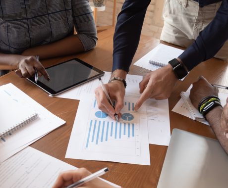 People discussing charts at table