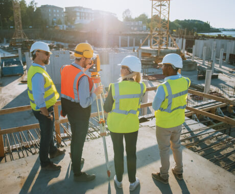 Group of building engineers talking at construction site